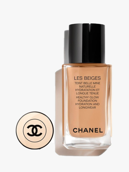 Chanel Les Beiges Healthy Glow Foundation bottle of foundation with black cap and gold cap top to the side on light gray background